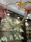 Gold plated moissanite necklace set with emerald coloured stone